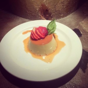 Faln with strawberry and basil leaf on white plate