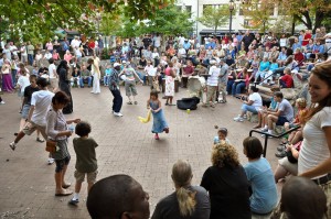 Dancing people in center of drum circle