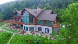 Aerial View of lodge with forest in background.