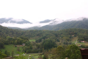 Mountain views mostly green and wispy clouds