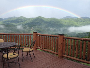 Rainbow over green mountainscape