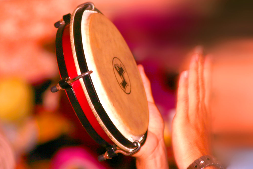 Hand playing tambourine