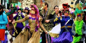 Woman dancing with purple hair and golden dress for mardi gras