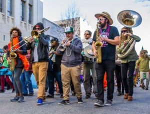 People marching in street playing instruments