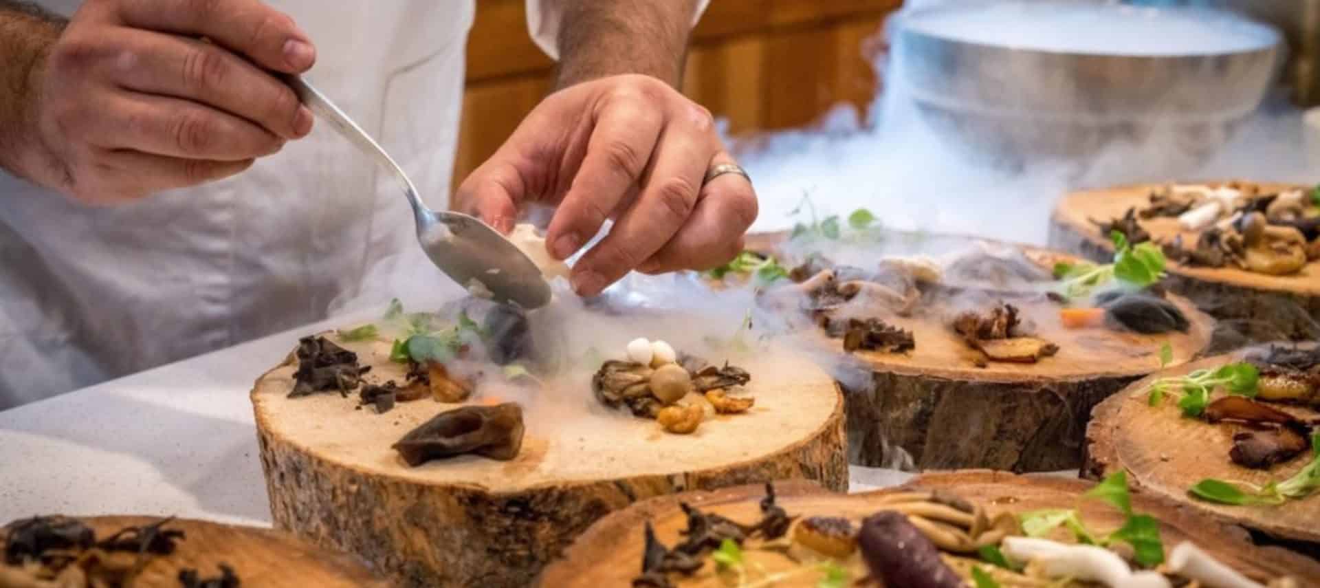 Man's hands finishing appetizer on rustic log