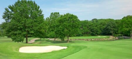 golf course with sand trap and green