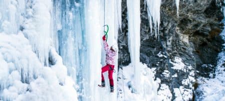 A person is ice climbing outside