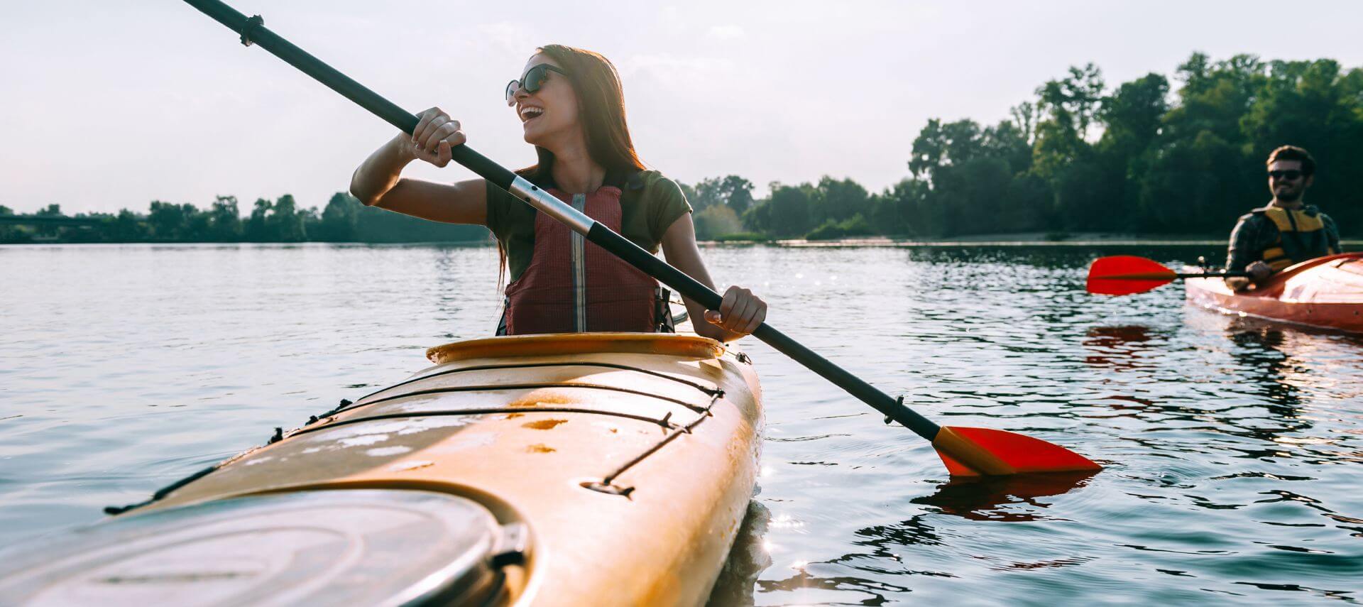 romantic couple kayaking a river