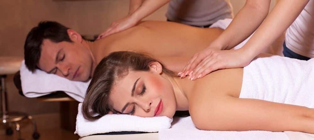 man and woman receiving a couple’s massage