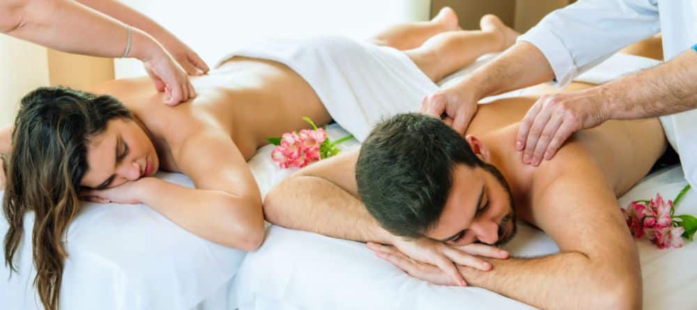 a couple receiving a side-by-side massage