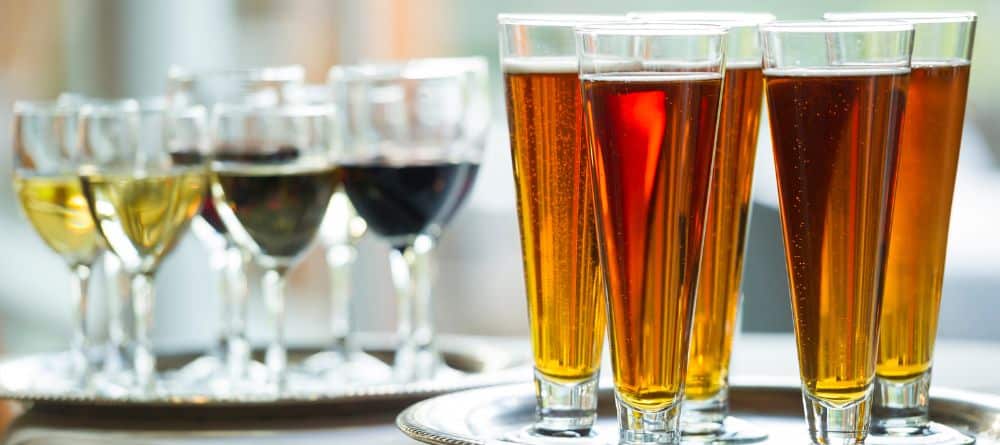 a flight of wine next to a flight of beer