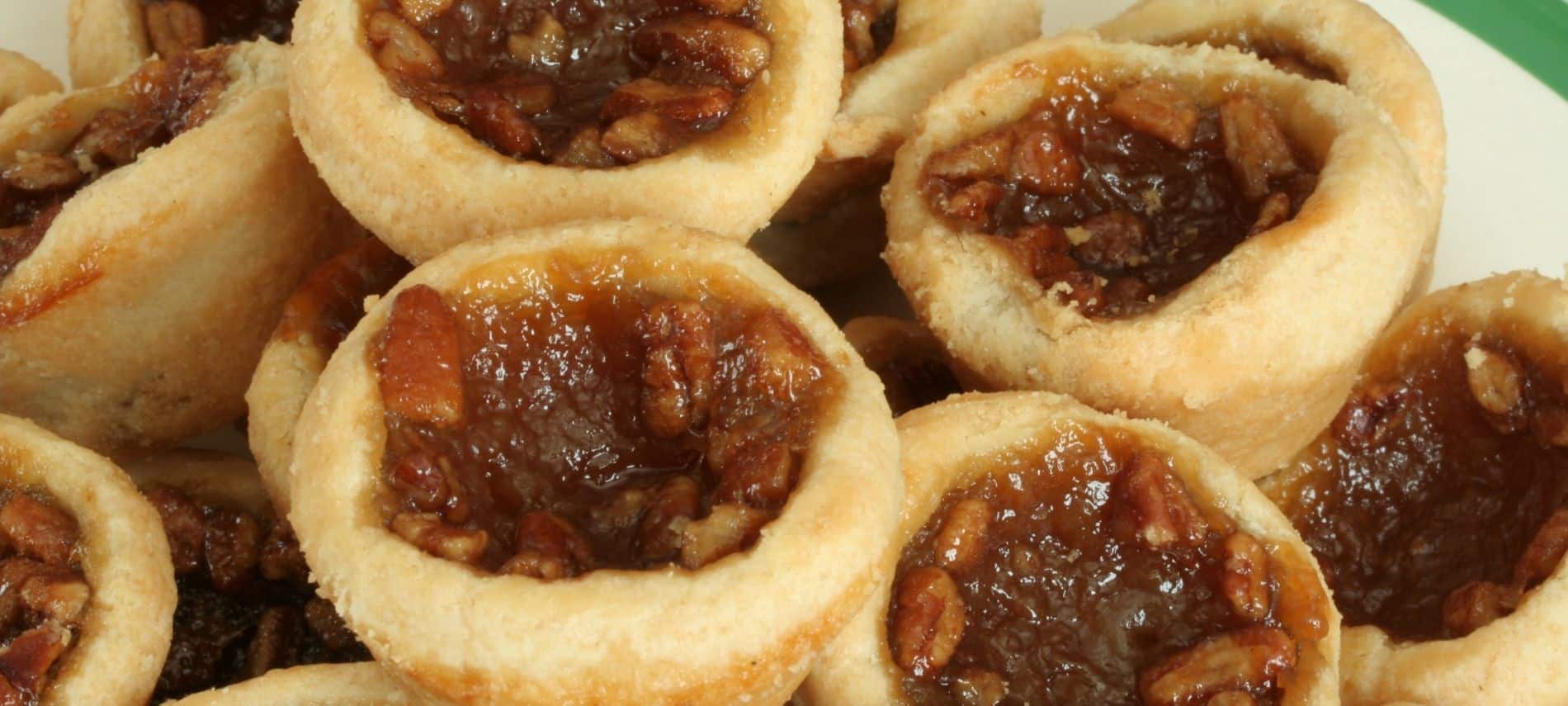 Plate full of freshly bakes pecan tarts